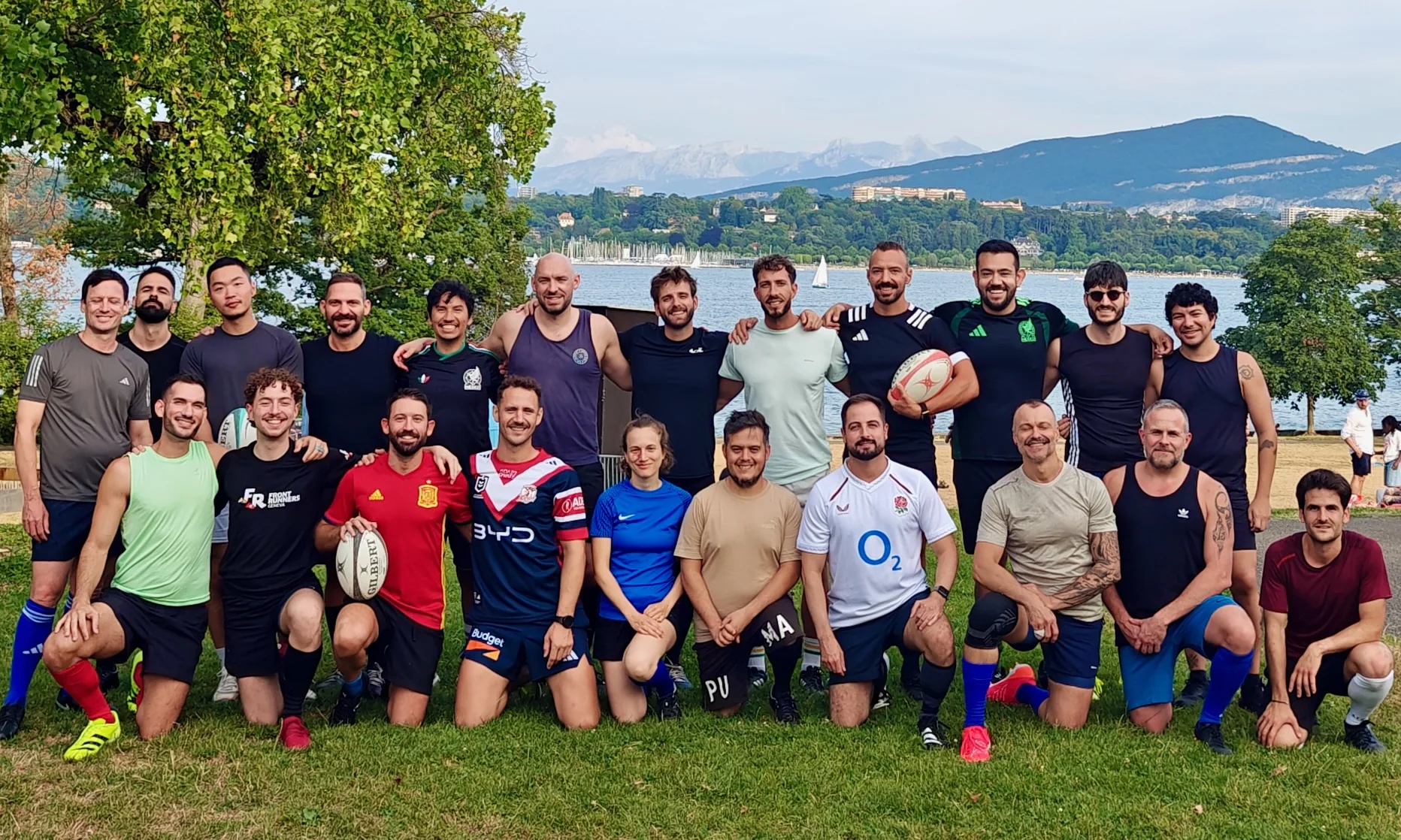 The Guardians together beside the lake with rugby balls